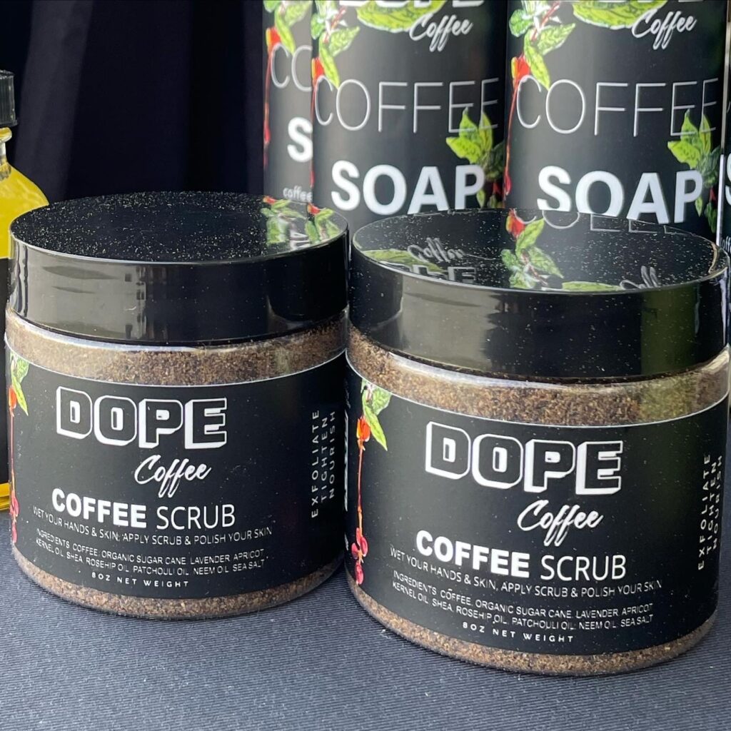 Dope Coffee Coffee Scrub jars beside Coffee Soap, the scrub ingredient list visible on the label